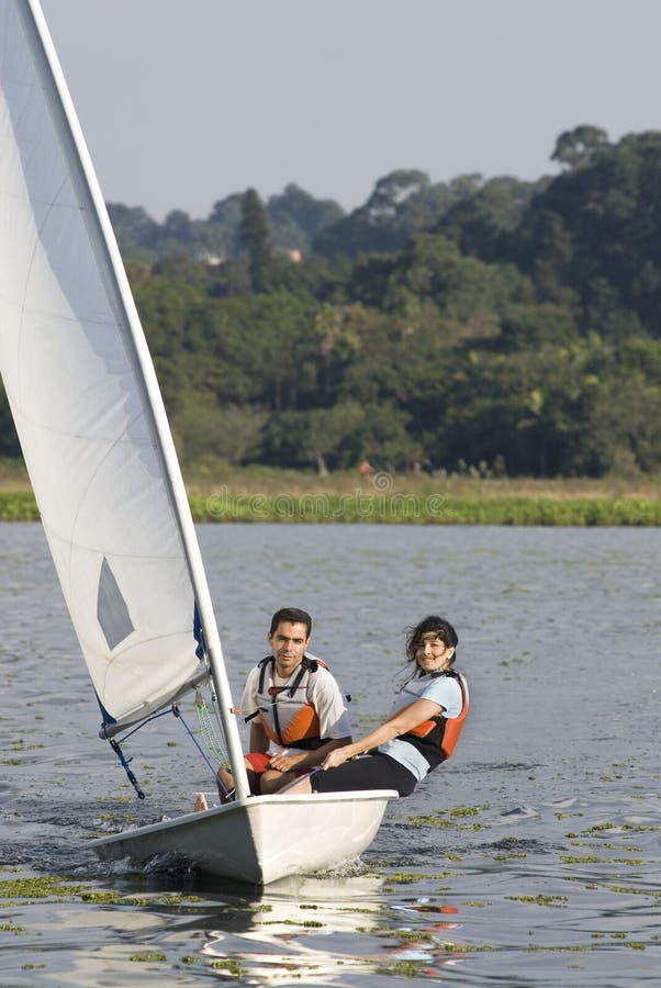 Couple Sailing Across Lake - Vertical
