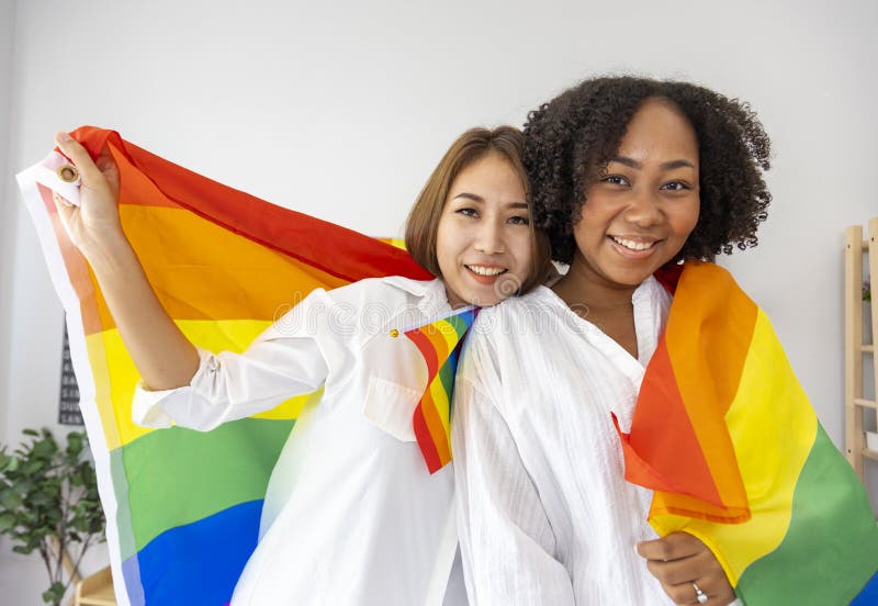 Couple Of Same Sex Marriage From Difference Races Holding Lgbtq Rainbow Flag For Pride Month