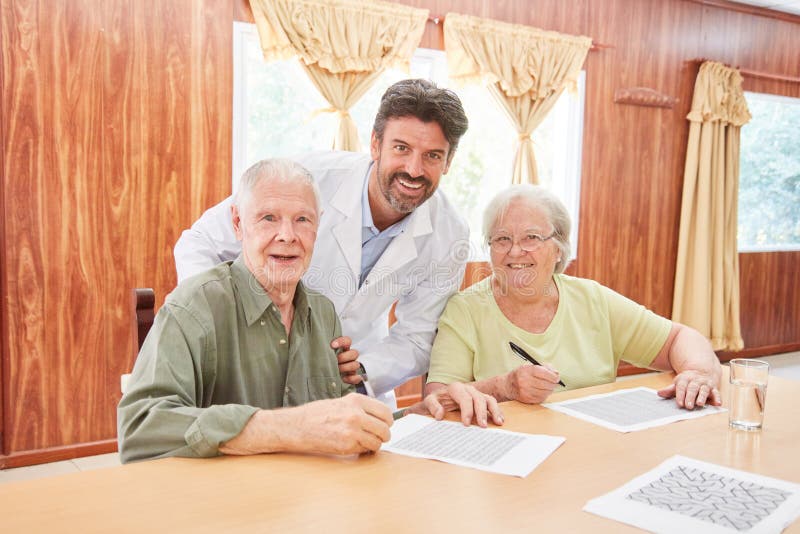 Couple of Seniors Doing Memory Training in Nursing Home Stock Image