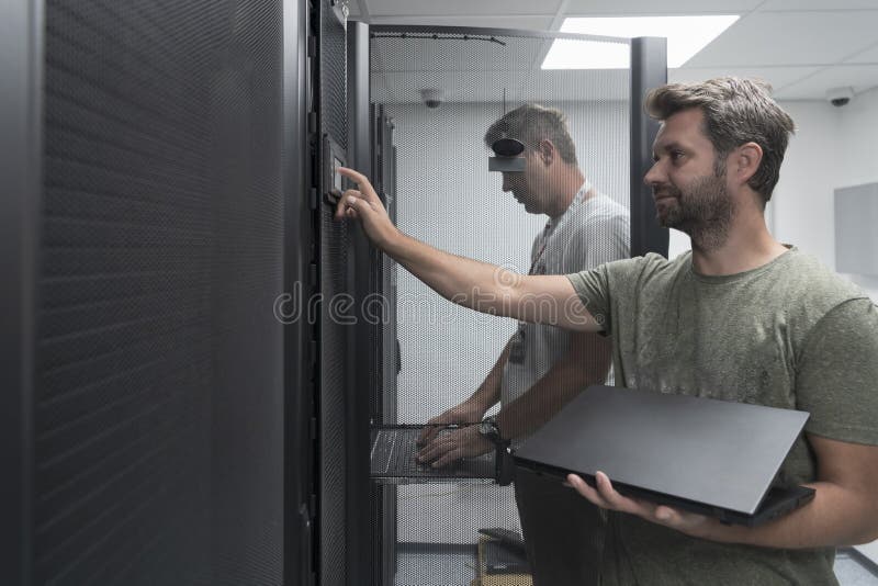 Technicians team updating hardware inspecting system performance in super computer server room or cryptocurrency mining royalty free stock images