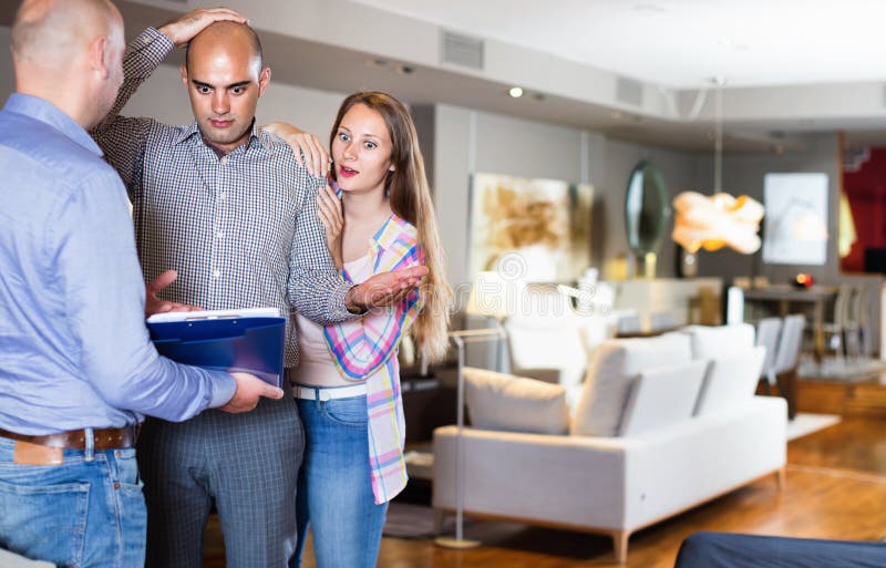 Couple shocked from looking through price-list royalty free stock photos Couple shocked from looking through price-list royalty free stock photos