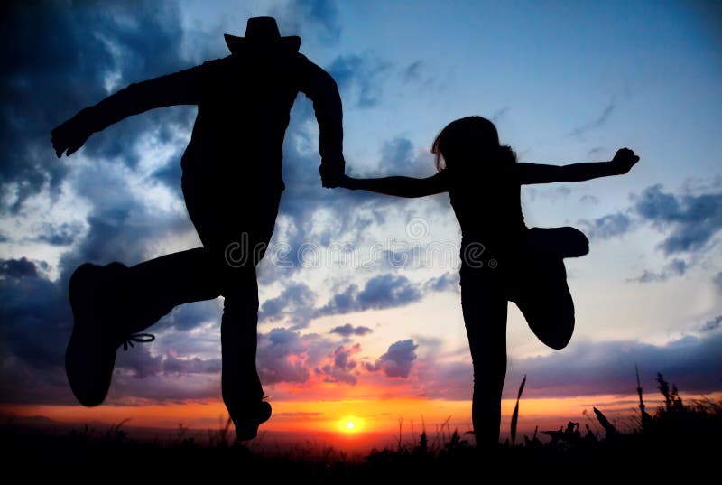 Couple silhouette running to the sunset royalty free stock photos