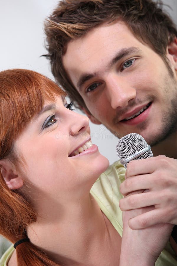 Couple singing karaoke stock photo. Image of party, 25753386