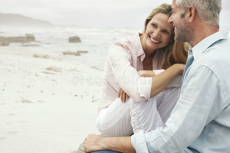 Couple Sitting On Beach