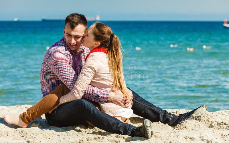 Couple Hugging Sitting On The Sand Of The Beach Stock Photos Image | My ...