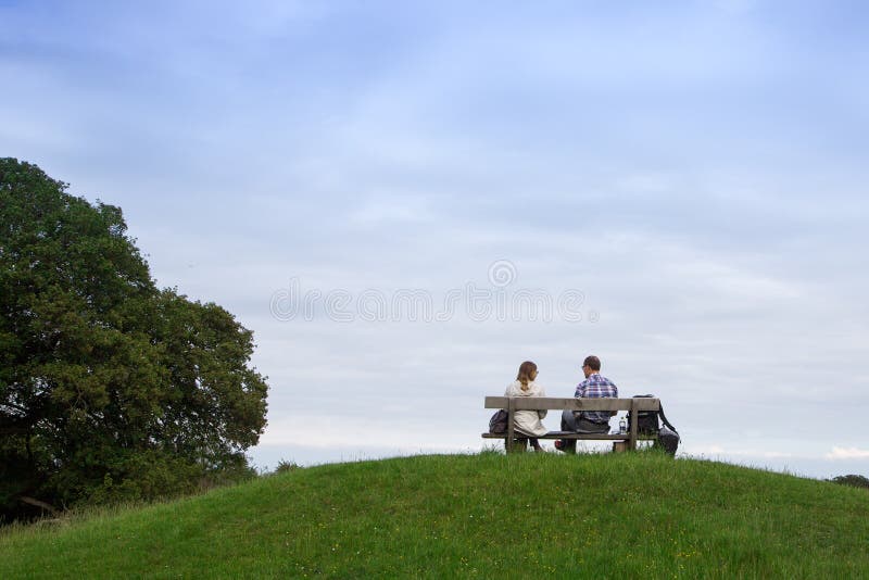 Couple Sitting on Bench in Park. Lovers on the Bench Stock Photo