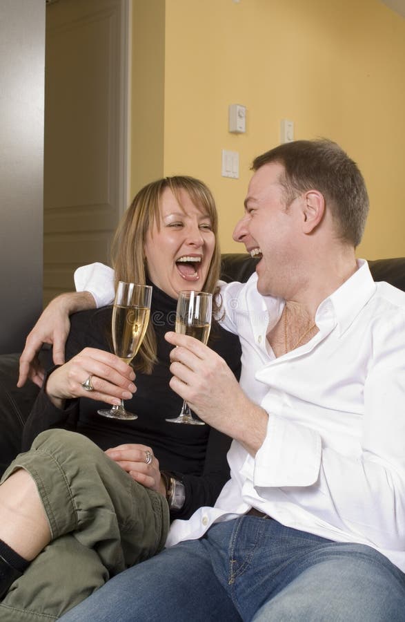 Couple sitting on black couch