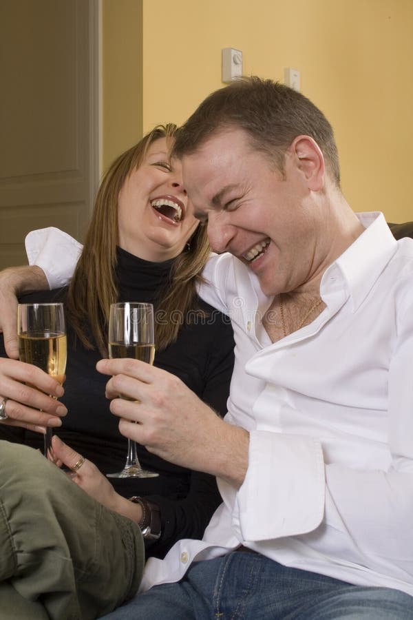 Couple sitting on black couch