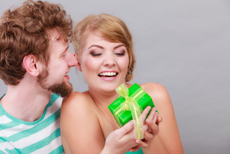 Young man giving woman gift box