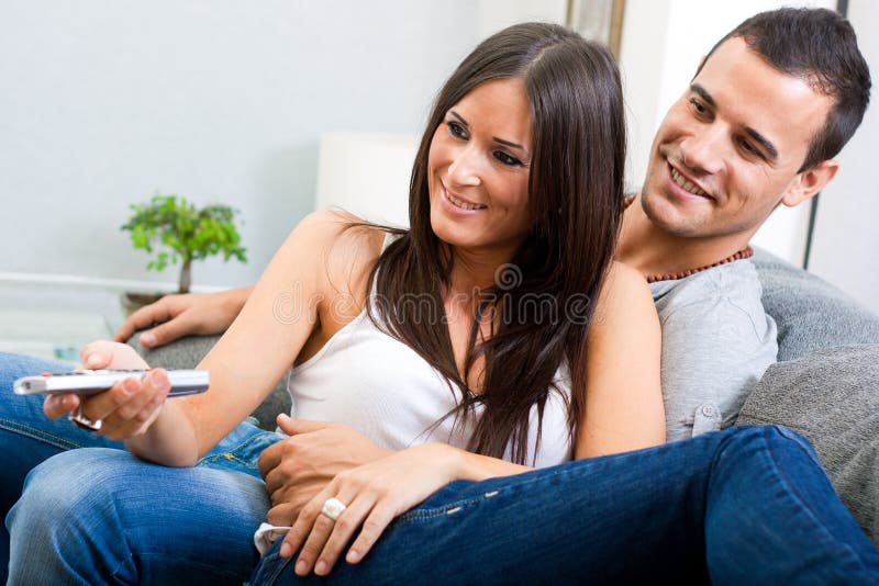 Couple Sitting on Couch and Watching Television To Stock Image Image
