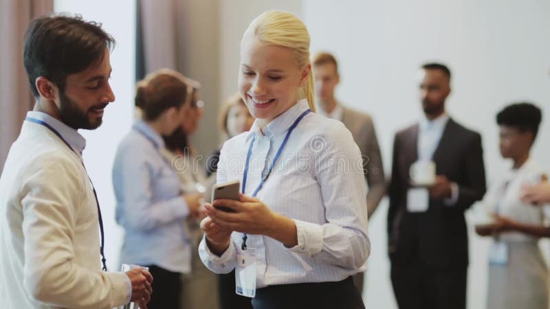 Couple with smartphone at business conference