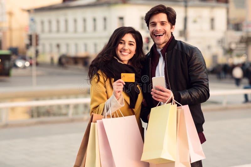 Couple with smartphone and credit card near city center royalty free stock photo Couple with smartphone and credit card near city center royalty free stock photo