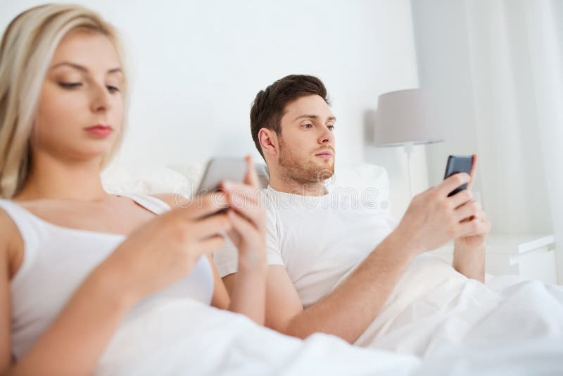 Couple With Smartphones In Bed Stock Image Image Of Gadget