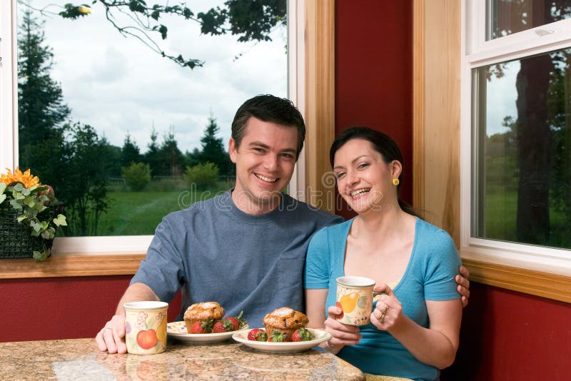 A Couple Smiling Over Breakfast at Home