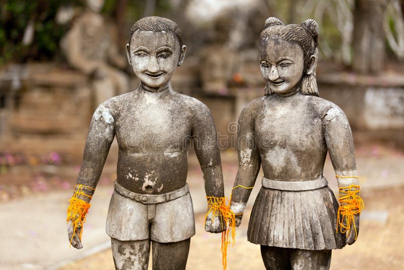 Stone religious sculpture of couple holding hands, thailand. Stone religious sculpture of couple holding hands, thailand