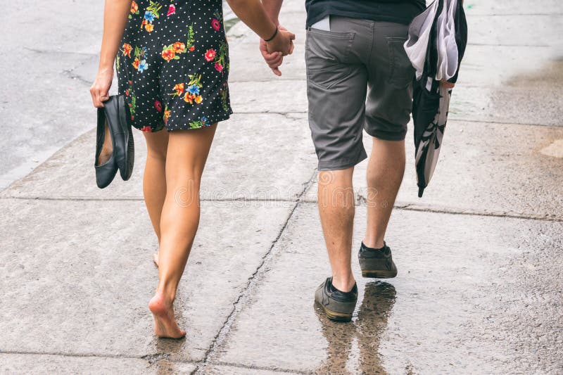 https://thumbs.dreamstime.com/b/couple-street-under-rain-couple-street-under-rain-woman-walking-barefoot-110582915.jpg