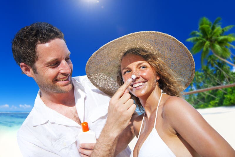 Couple Sun Protection on the Beach royalty free stock photo Couple Sun Protection on the Beach royalty free stock photo