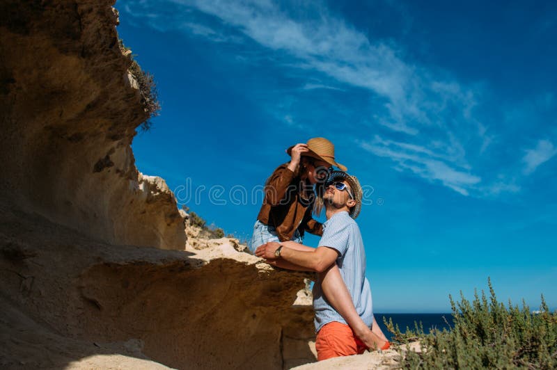 Couple in sunglasses embrace in the day in the hills royalty free stock photography Couple in sunglasses embrace in the day in the hills royalty free stock photography