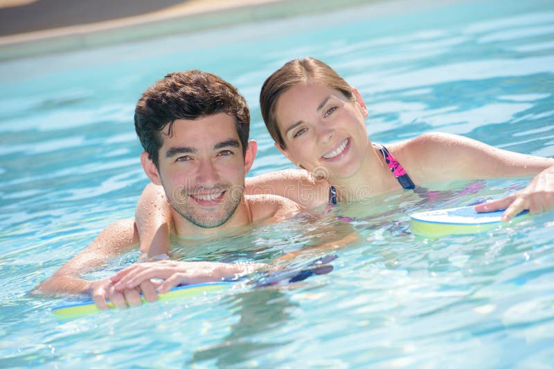 Couple in Swimming Pool Using Floats Stock Image Image of novice