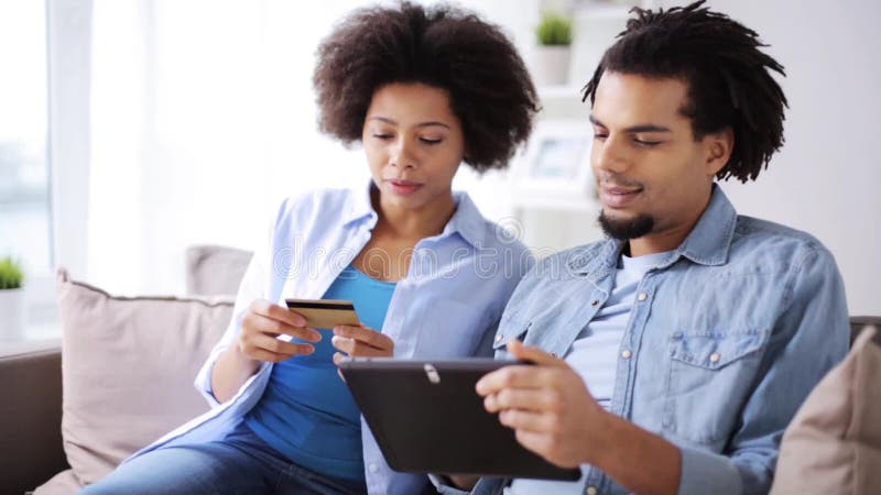 Couple with tablet pc and credit card at home