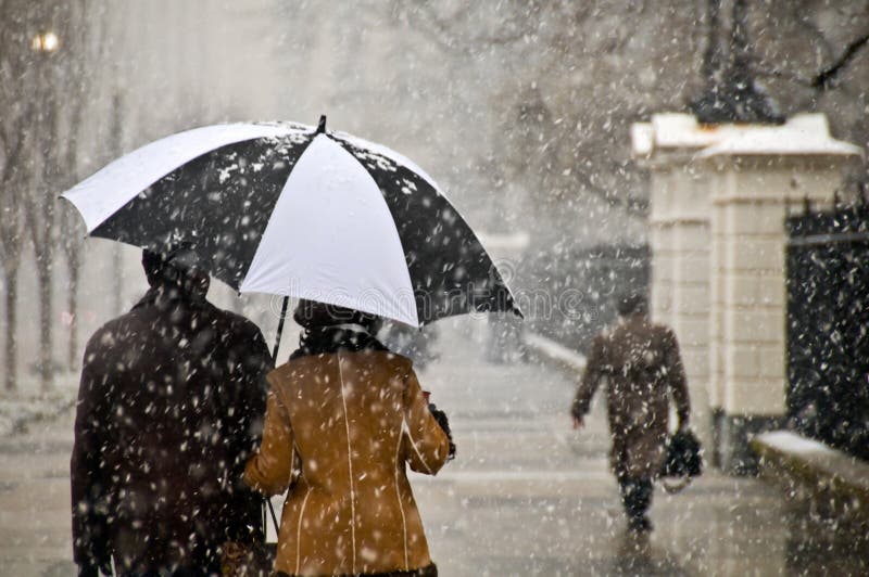 Walking arm in arm along Pennsylvania Ave in Washington, DC during a snow storm. Walking arm in arm along Pennsylvania Ave in Washington, DC during a snow storm.