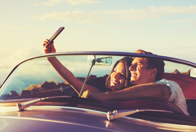 Couple Taking a Selfie in Car at Sunset stock photography Couple Taking a Selfie in Car at Sunset stock photography