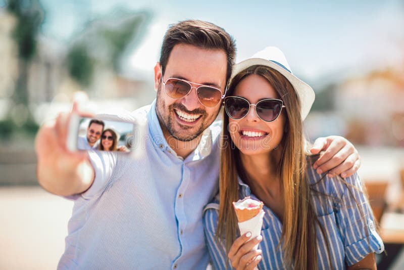 Couple taking selfie photograph in city stock image Couple taking selfie photograph in city stock image