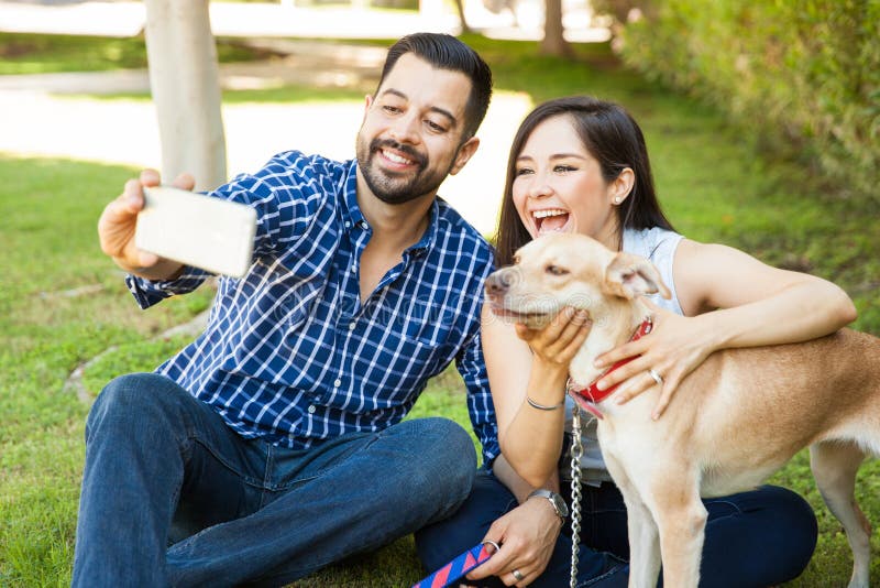 Couple taking selfie with their dog royalty free stock photos Couple taking selfie with their dog royalty free stock photos