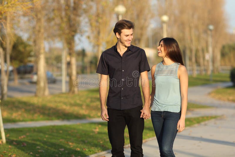 Couple taking a walk in a park stock photo Couple taking a walk in a park stock photo