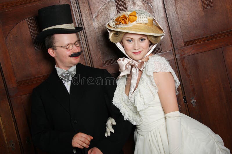 Couple in 19th century garment with woman in dominant role royalty free stock images Couple in 19th century garment with woman in dominant role royalty free stock images