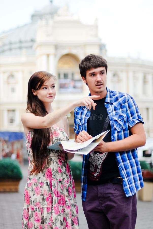 Couple of tourists looking on map in city centre