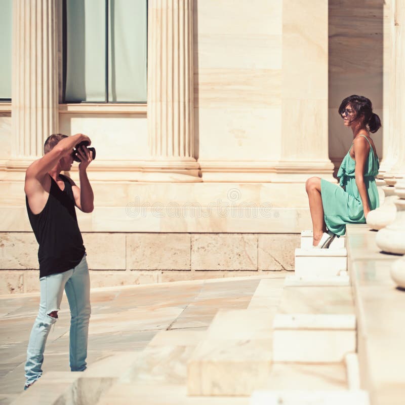A couple of tourists visiting the Ancient Museum with man photographer and girl on stairs royalty free stock image A couple of tourists visiting the Ancient Museum with man photographer and girl on stairs royalty free stock image