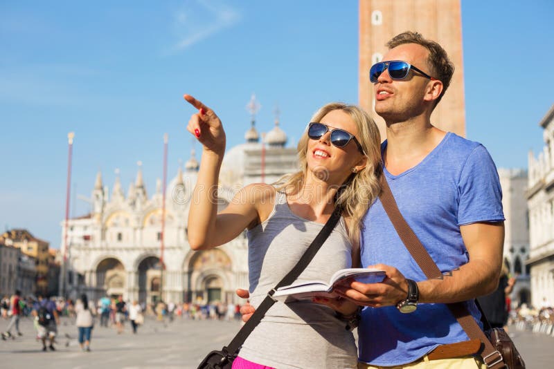 Couple traveling and reading tourist guide