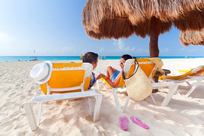 Couple under parasol at Caribbean Sea