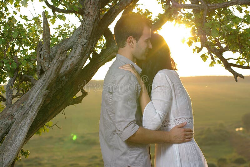 Couple under tree at summer day