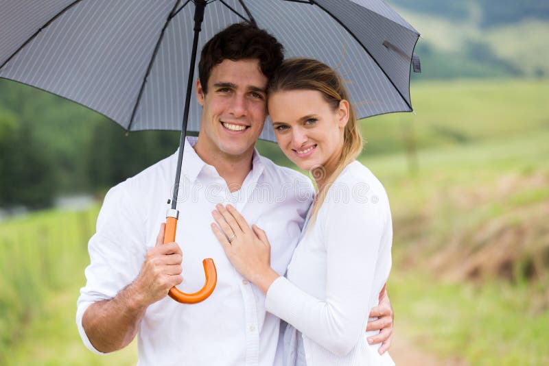Couple under umbrella stock photo. Image of loving, attractive 50964038
