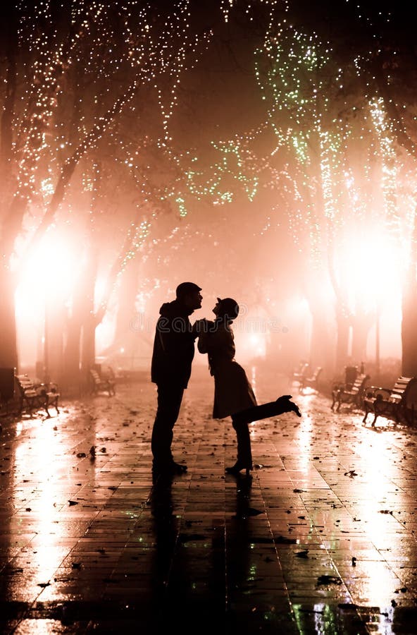 Couple walking at alley in night lights. stock photography Couple walking at alley in night lights. stock photography
