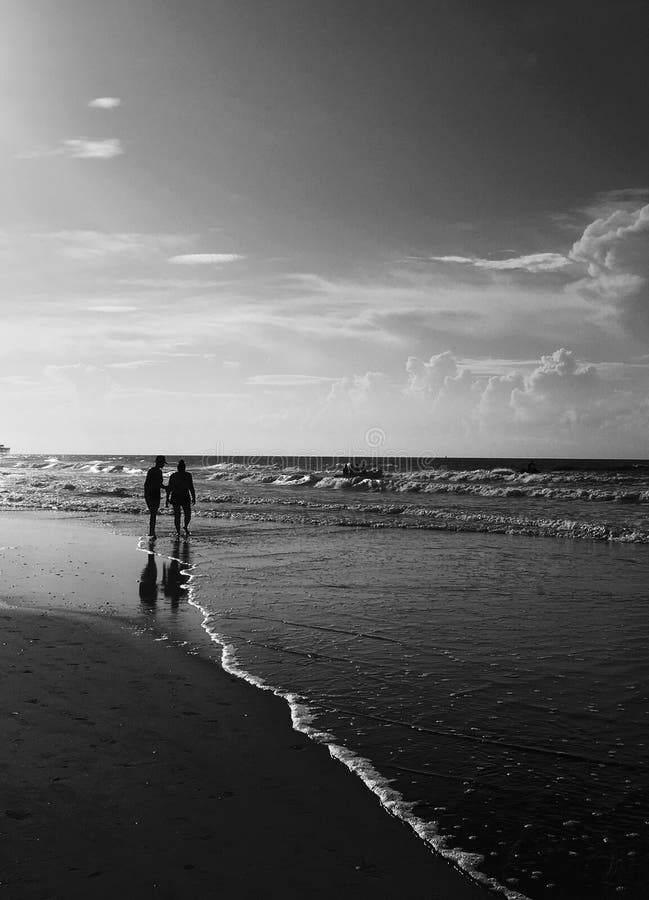 Couple walking on beach stock image. Image of black - 116487231