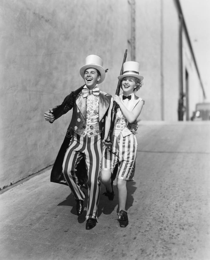 Couple walking down a street in a patriotic outfit (All persons depicted are no longer living and no estate exists. Supplier grants that there will be no model release issues.)