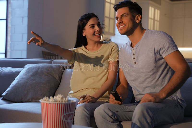 Couple Watching Movie with Popcorn on Sofa at Night Stock Image Image