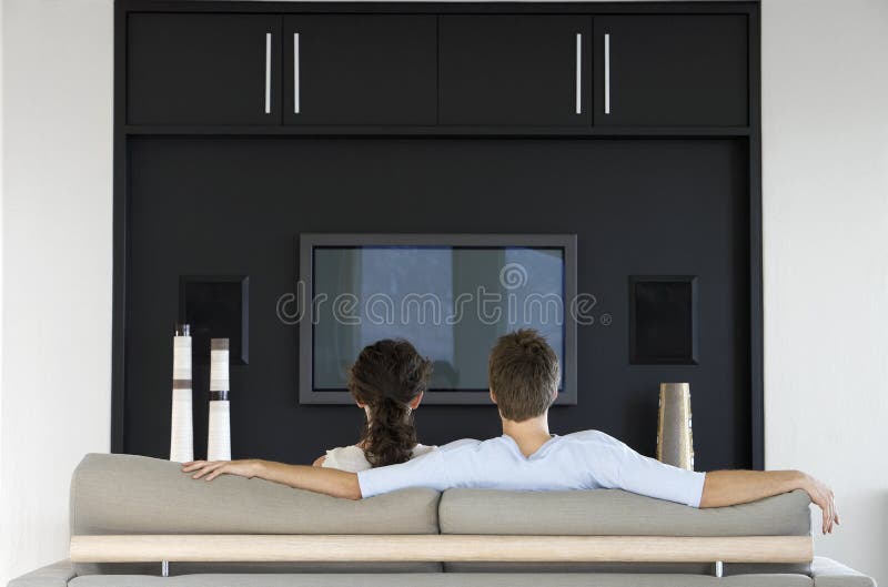 Couple Watching TV Together In Living Room stock photos Couple Watching TV Together In Living Room stock photos