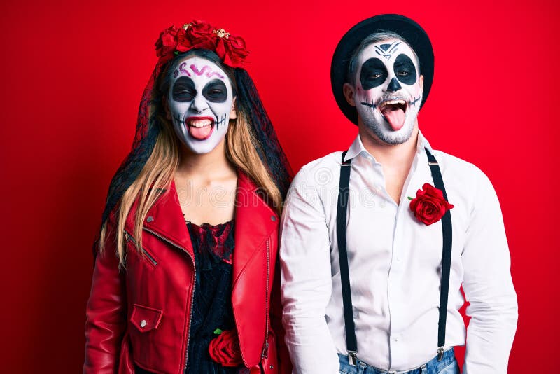 Couple Wearing Day of the Dead Costume Over Red Sticking Tongue Out ...