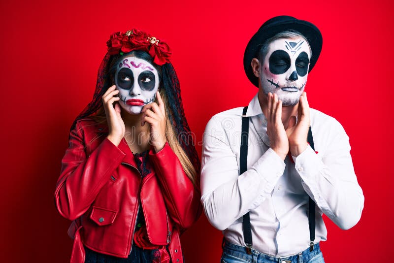 Couple Wearing Day of the Dead Costume Over Red Tired Hands Covering ...