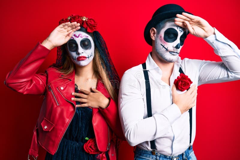 Couple Wearing Day of the Dead Costume Over Red Touching Forehead for ...