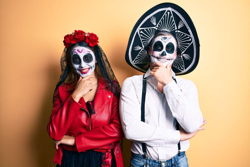 Couple Wearing Day of the Dead Costume Over Yellow Looking Confident at ...