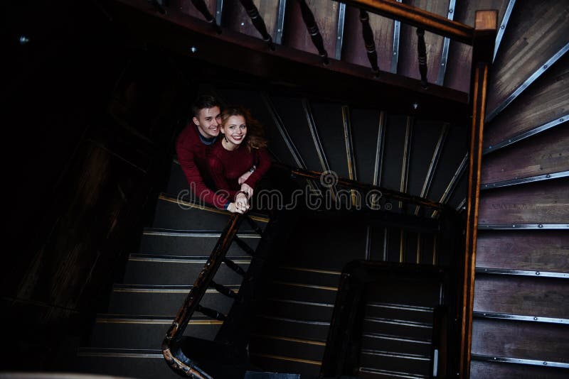 Couple of young people on the wooden stairs