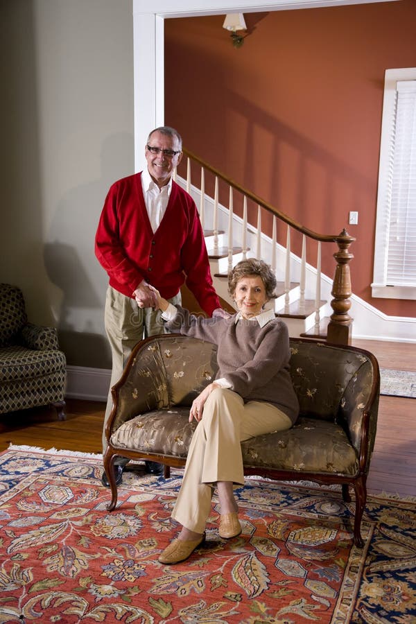 Couples aînés à la maison dans la salle de séjour photographie stock Couples aînés à la maison dans la salle de séjour photographie stock