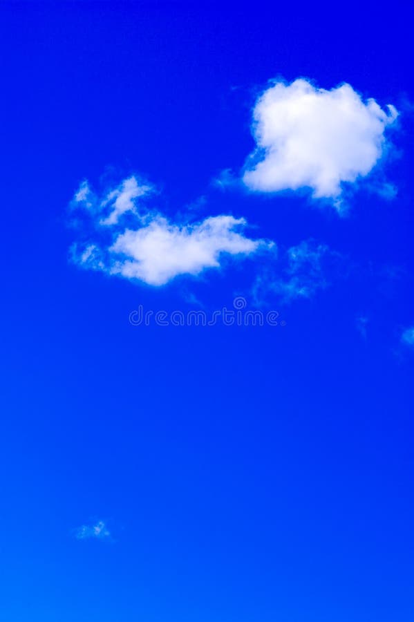 Couple of clouds in vivid blue sky vertical image of heaven. Couple of clouds in vivid blue sky vertical image of heaven