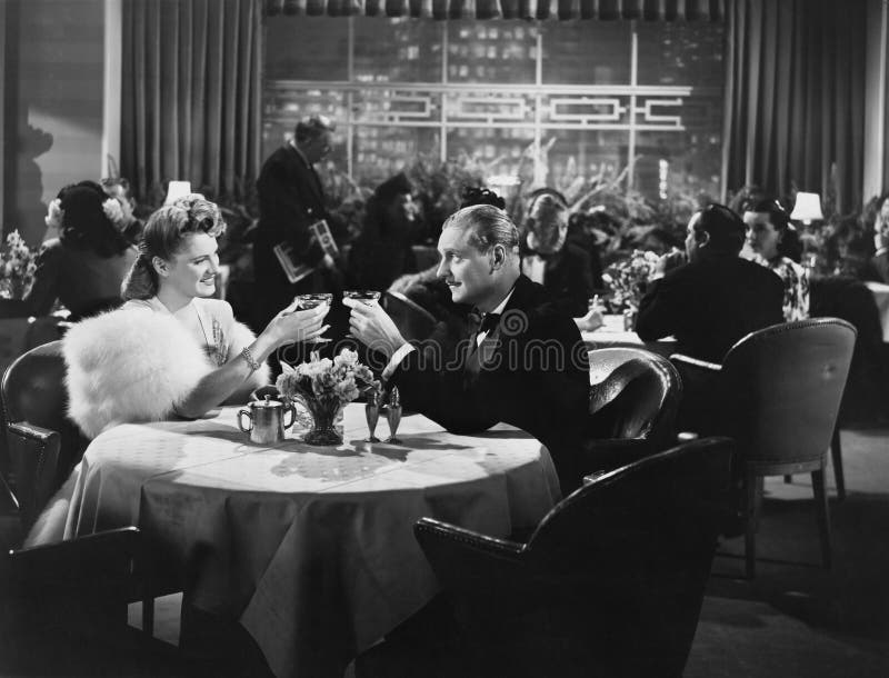 Couples dinant dans le restaurant serré (toutes les personnes représentées ne sont pas plus long vivantes et aucun domaine n'exis image stock Couples dinant dans le restaurant serré (toutes les personnes représentées ne sont pas plus long vivantes et aucun domaine n'exis image stock
