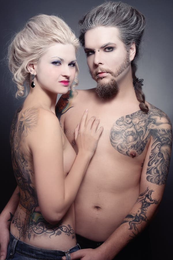 Pierced tattooed man and woman with old-fashioned make-up and hairstyle. Pierced tattooed man and woman with old-fashioned make-up and hairstyle
